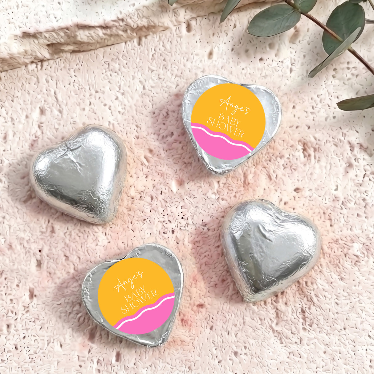Silver foil heart chocolates with “Ange’s Baby Shower” label, wavy pink-orange stripe