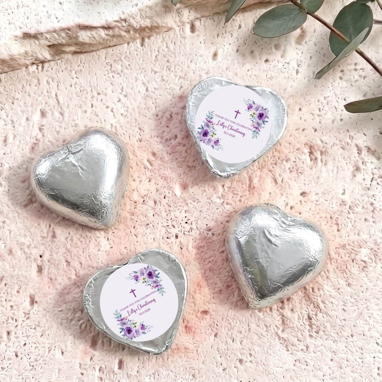 Silver foil-covered chocolate heart with personalized floral christening label