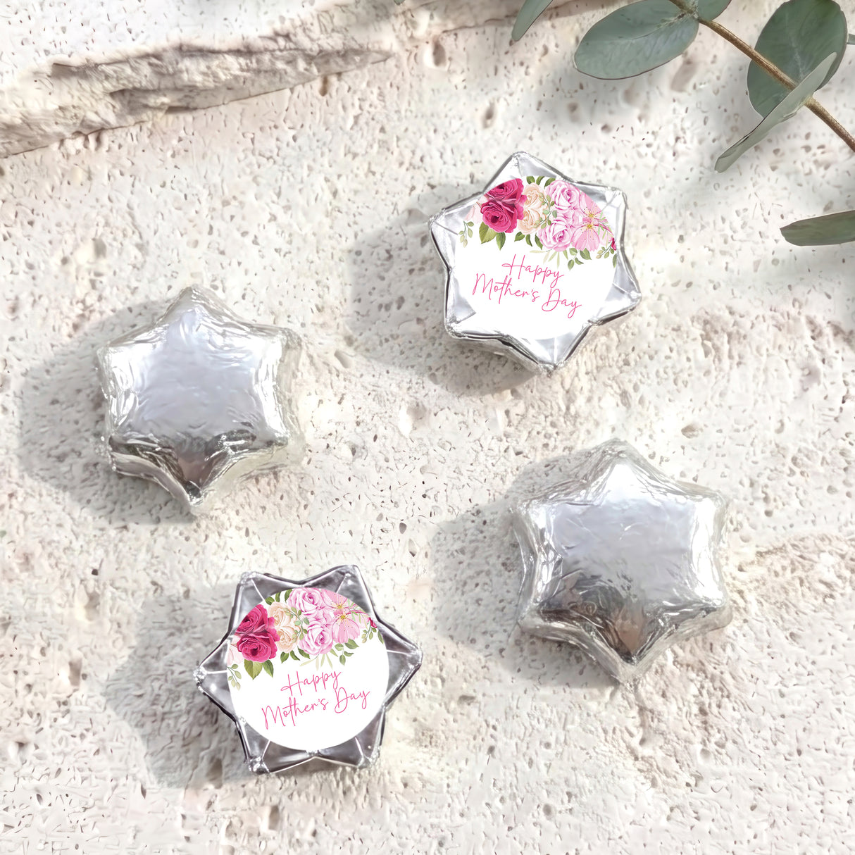Foil-covered silver chocolate stars, one with floral 'Happy Mother's Day' label