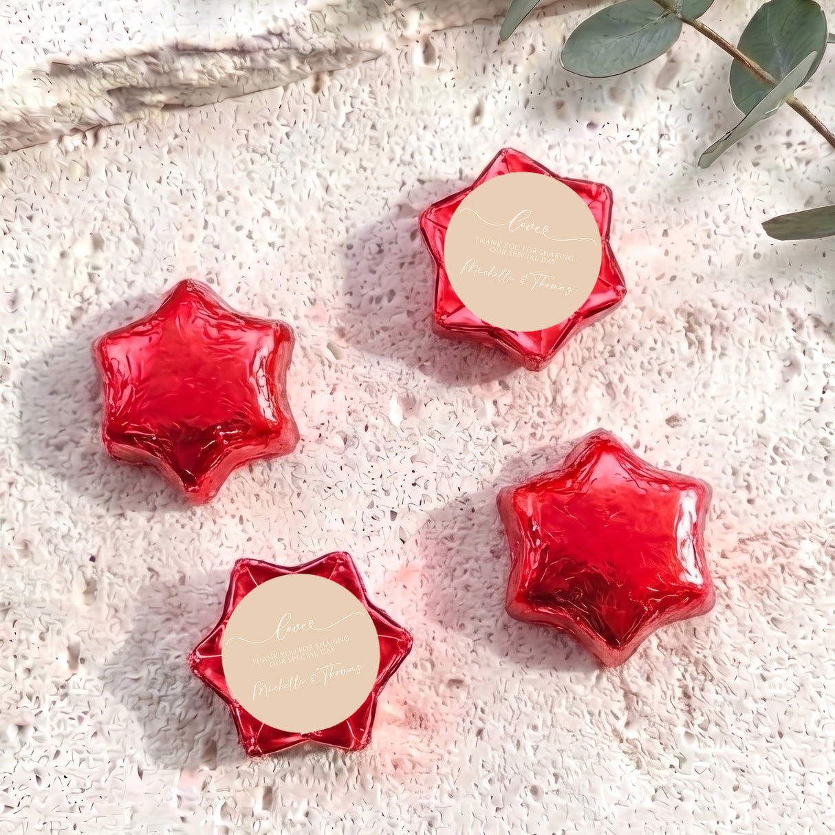 Red foil-covered chocolate stars with round name tag toppers
