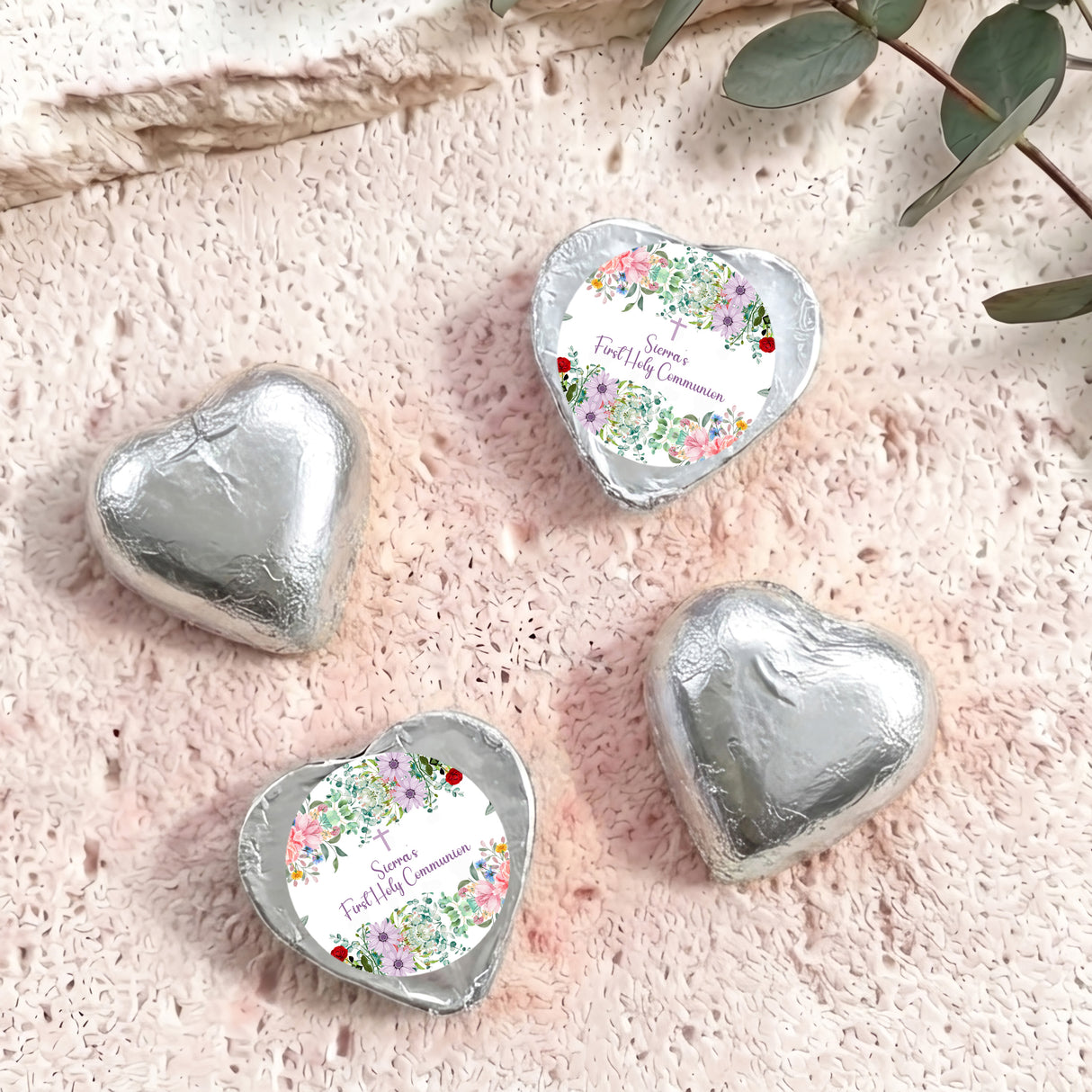Silver foil-covered chocolate hearts, three hearts with personalised First Holy Communion label