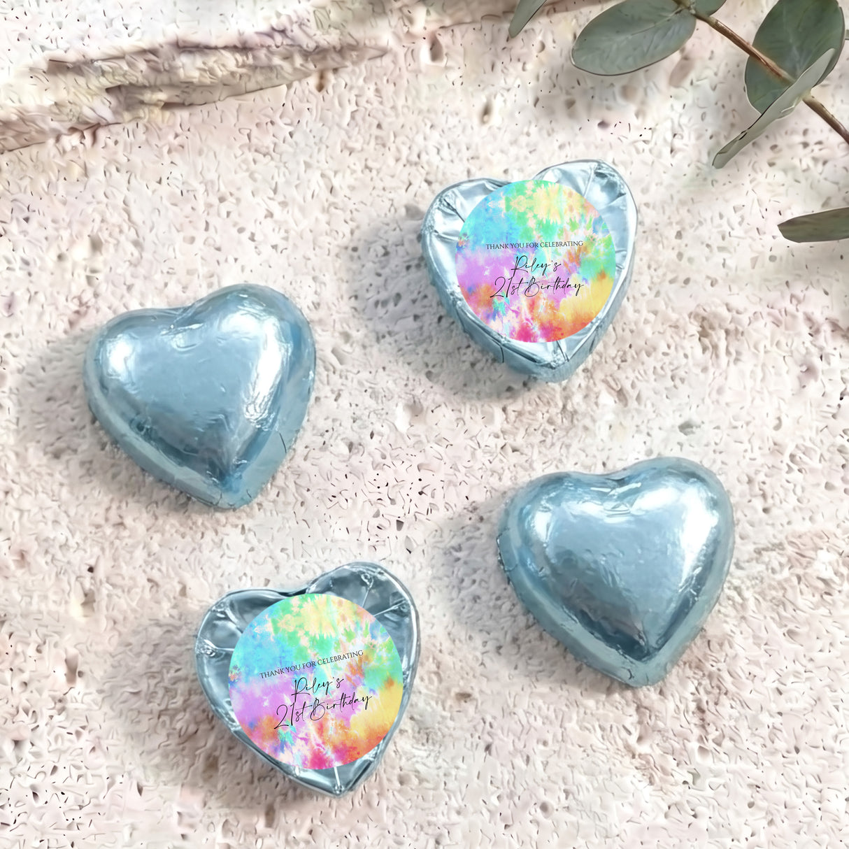 Light blue foil heart chocolates; two have tie-dye personalized print