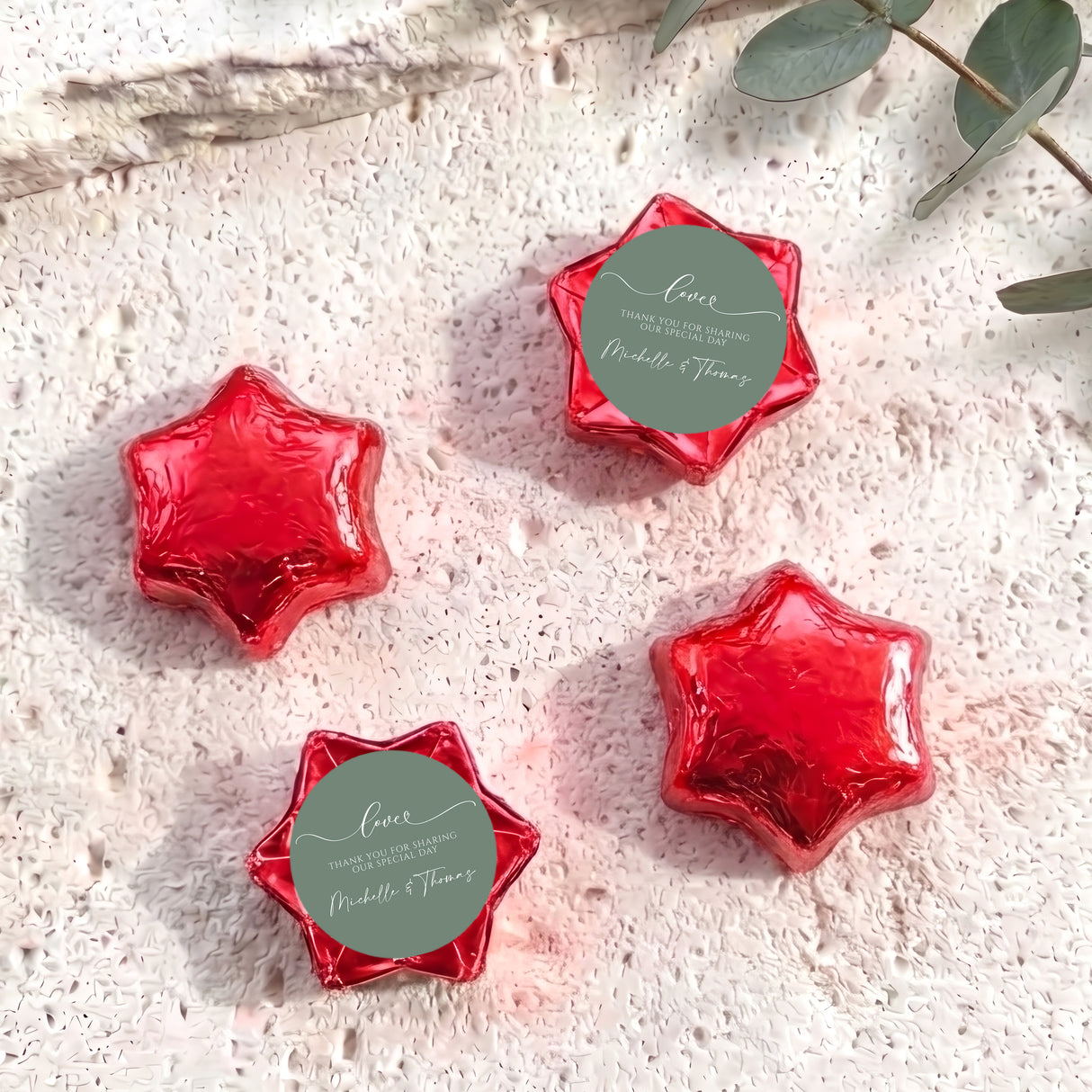 Foil-covered chocolate star favors with custom round tag, red five-point foil stars