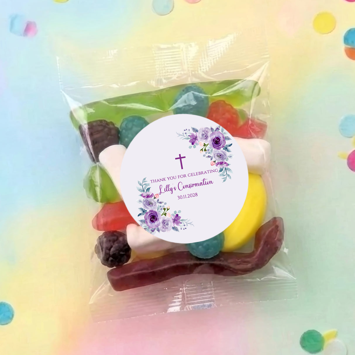 Personalised party lolly bag with clear wrap, assorted candies, and purple floral round label