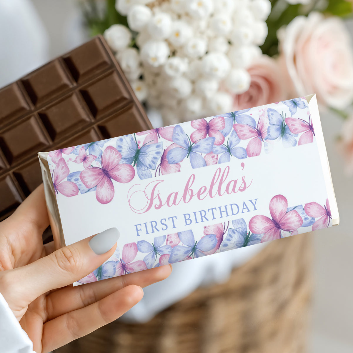 Wrapped chocolate bar with pastel butterfly design and "Isabella's First Birthday" text