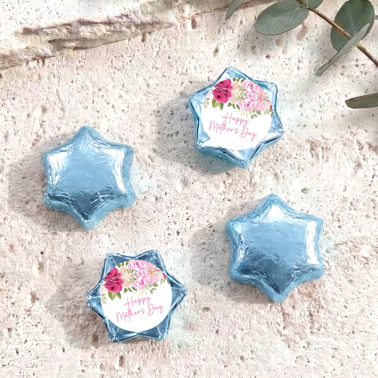 Foil-covered blue chocolate stars, one with floral 'Happy Mother's Day' label