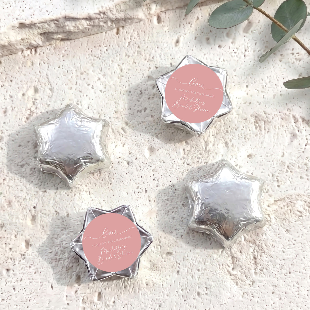 Set of silver foil-covered chocolate stars with a pink heart label