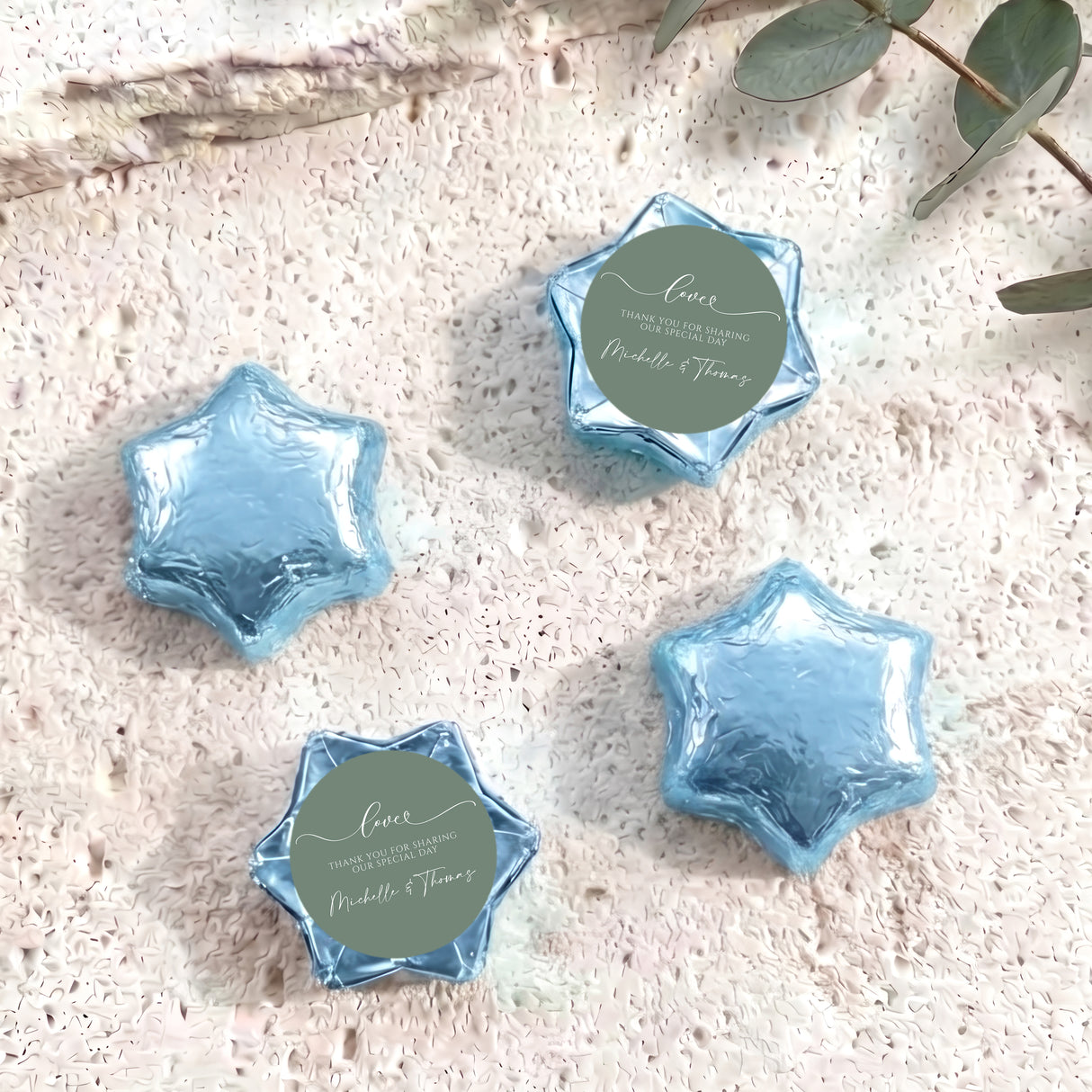 Foil-covered chocolate star favors with custom round tag, light blue five-point foil stars