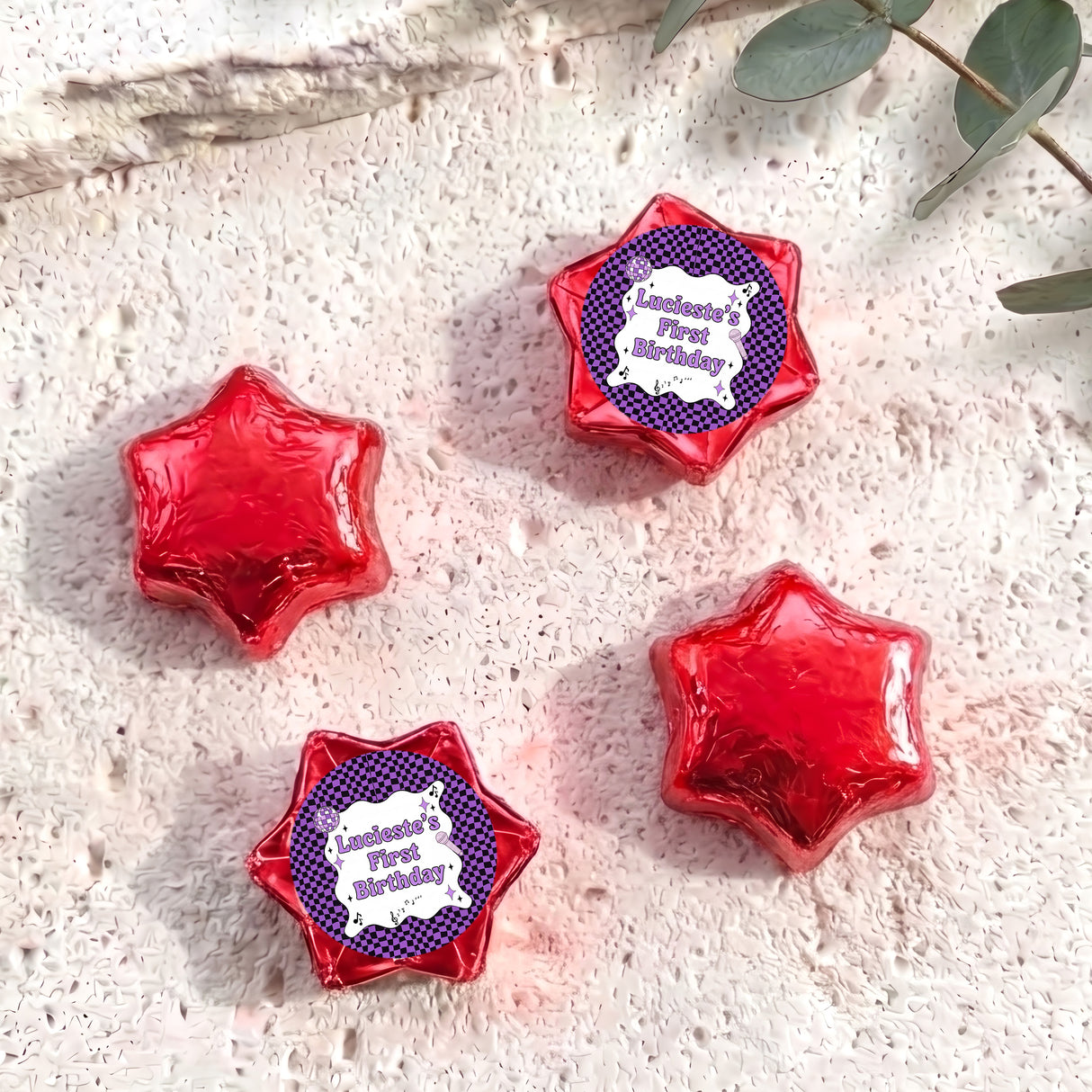 Foil-covered chocolate star candies in red with personalised 'Birthday' topper