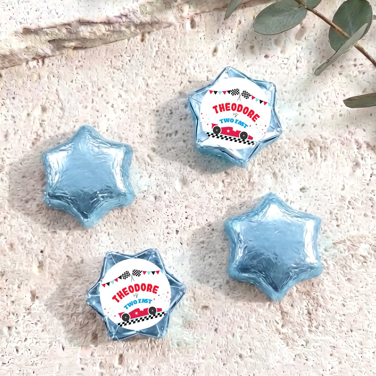 Blue foil-covered star chocolates with personalised label wrappers, four pieces shown