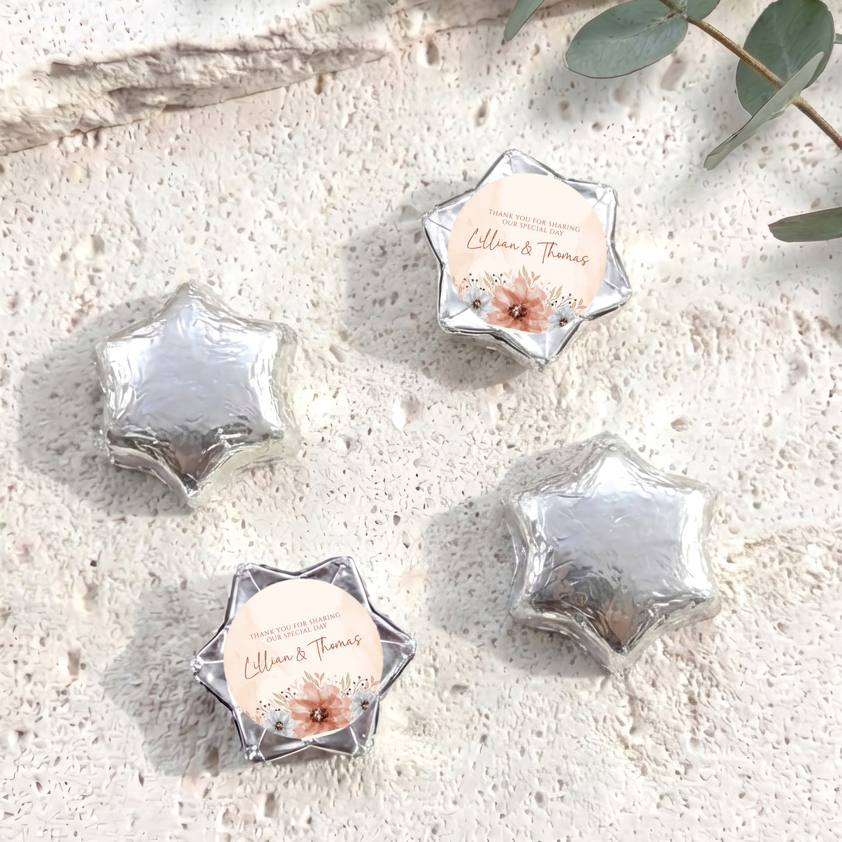 Personalised foil-covered chocolate stars with floral label, silver star-shaped chocolates