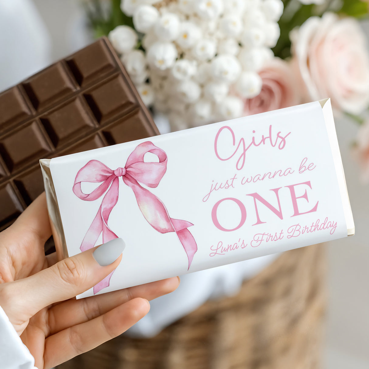First birthday chocolate bar with pink bow and 'Girls just wanna be ONE' text