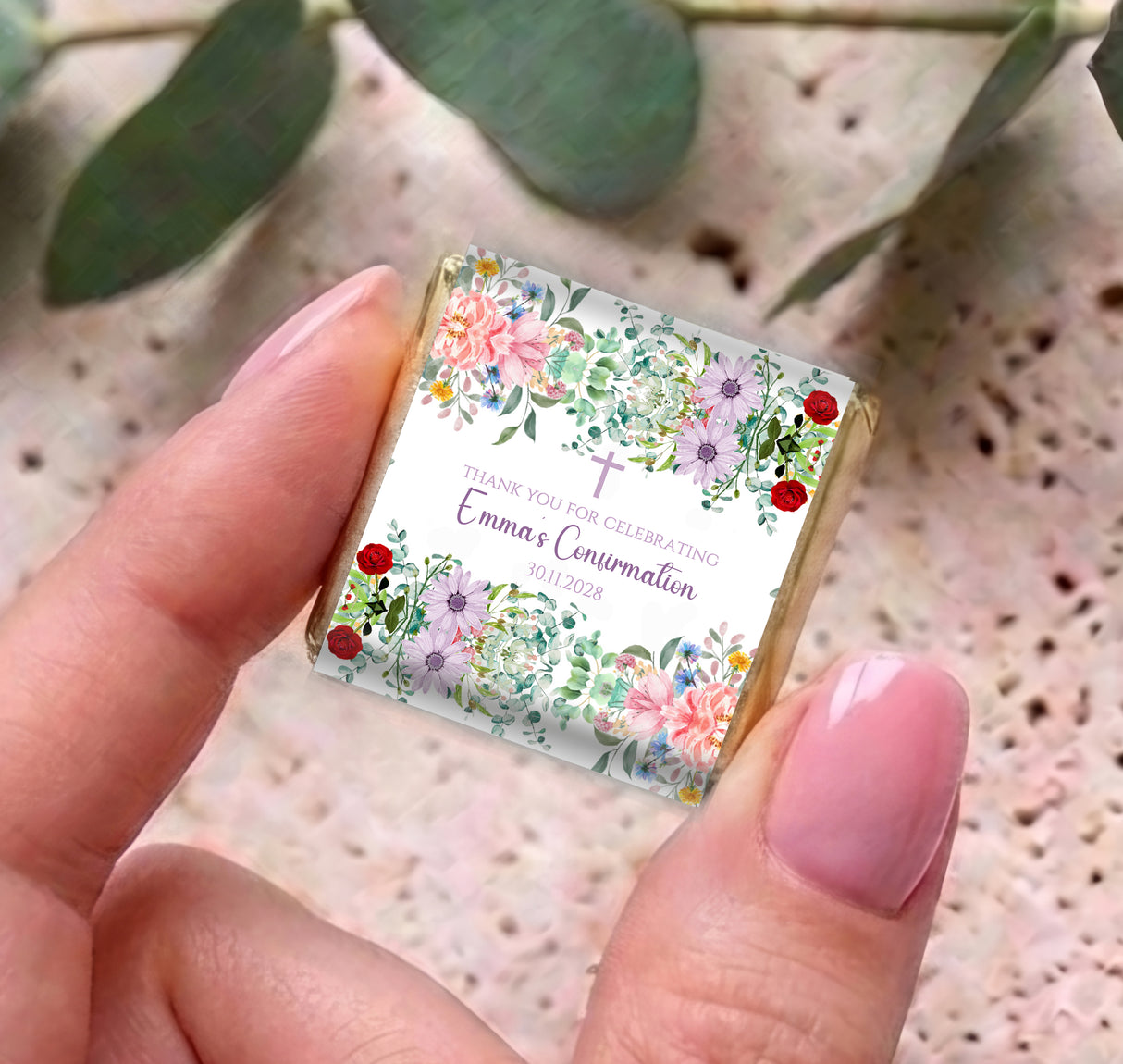 Personalised mini chocolates with floral thank you Confirmation label, held in hands