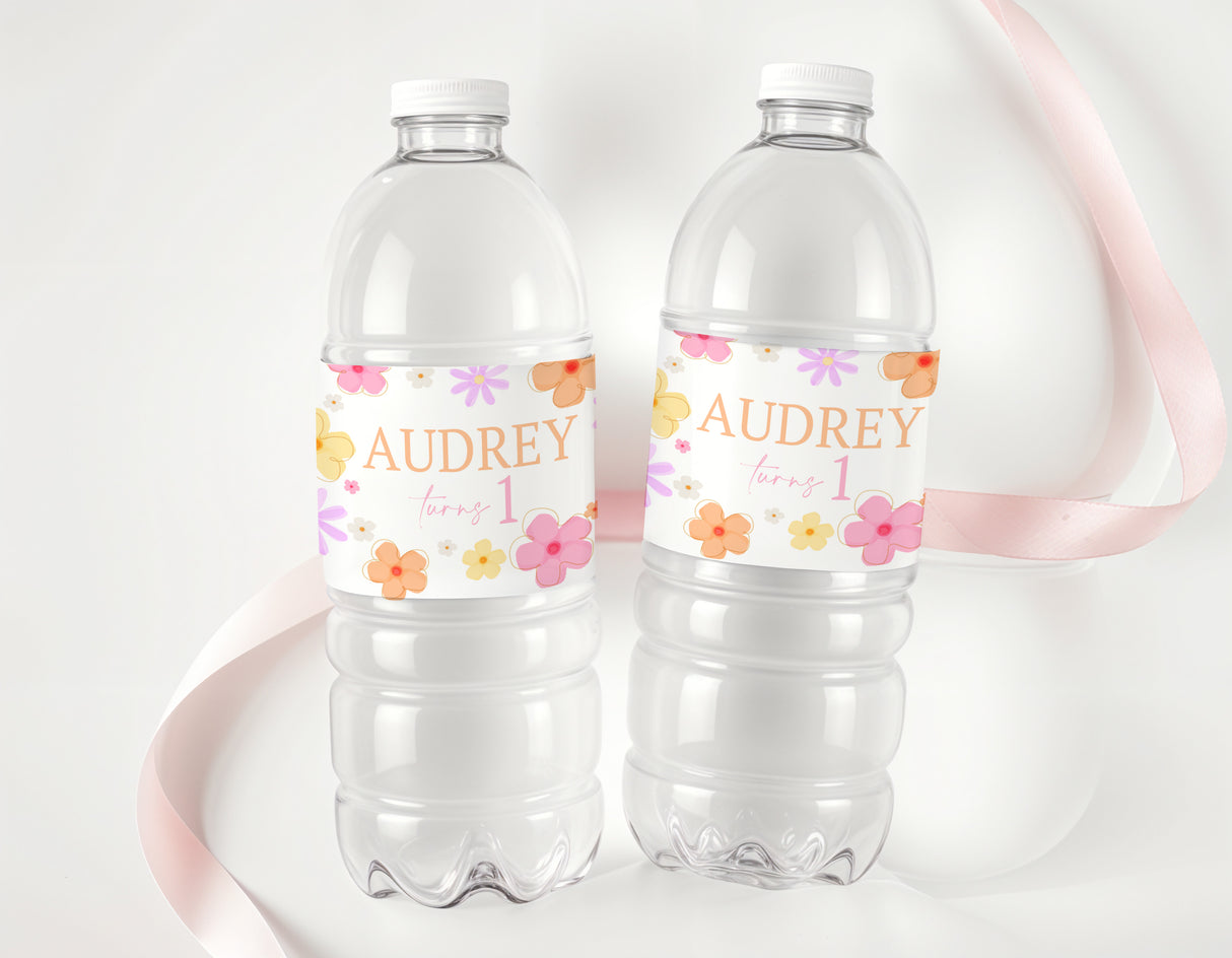 Two clear plastic water bottles with Retro Daisy labels, Audrey turning 1