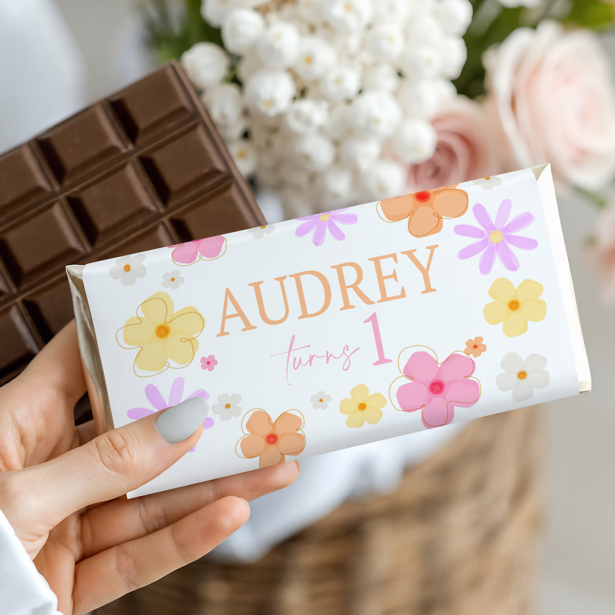Chocolate bar with colorful floral wrapper showing Audrey and turning 1