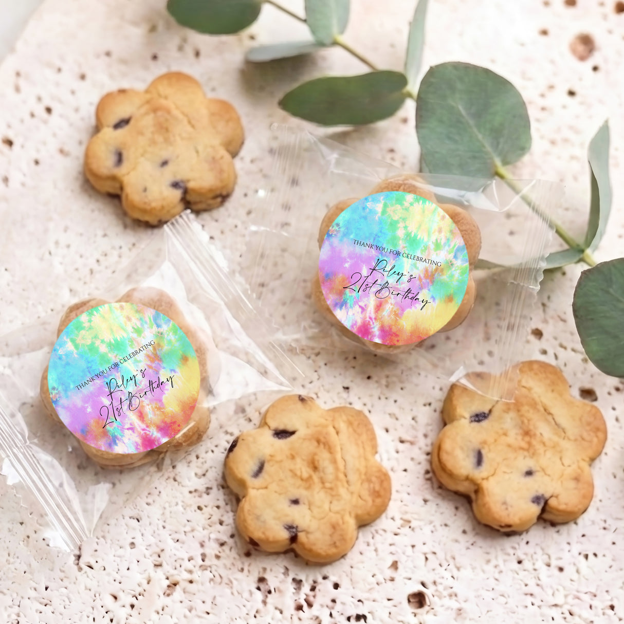 Personalized tie-dye cookie gifts with round labels and assorted cookies on tray