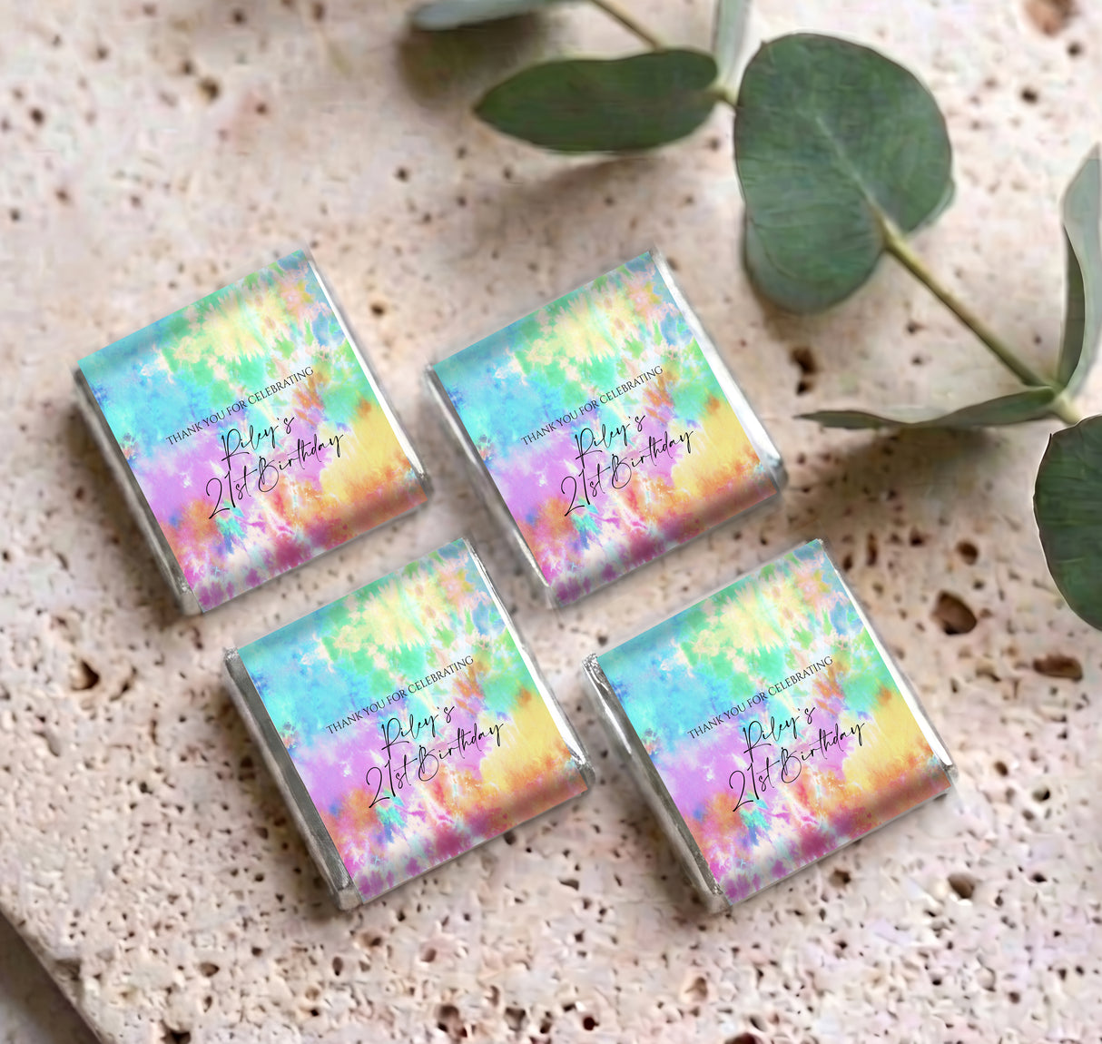 Set of four mini tie-dye wrapped chocolates with birthday personalised message on surface