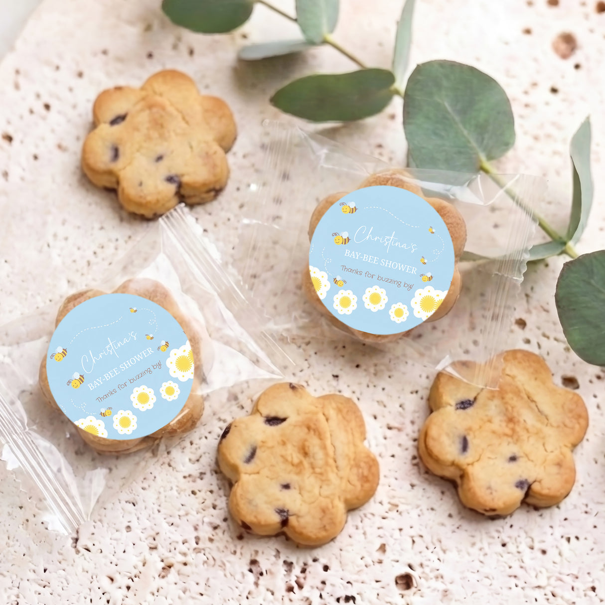 Bite-size chocolate chip cookies with blue round shower label, multiple wrapped cookies