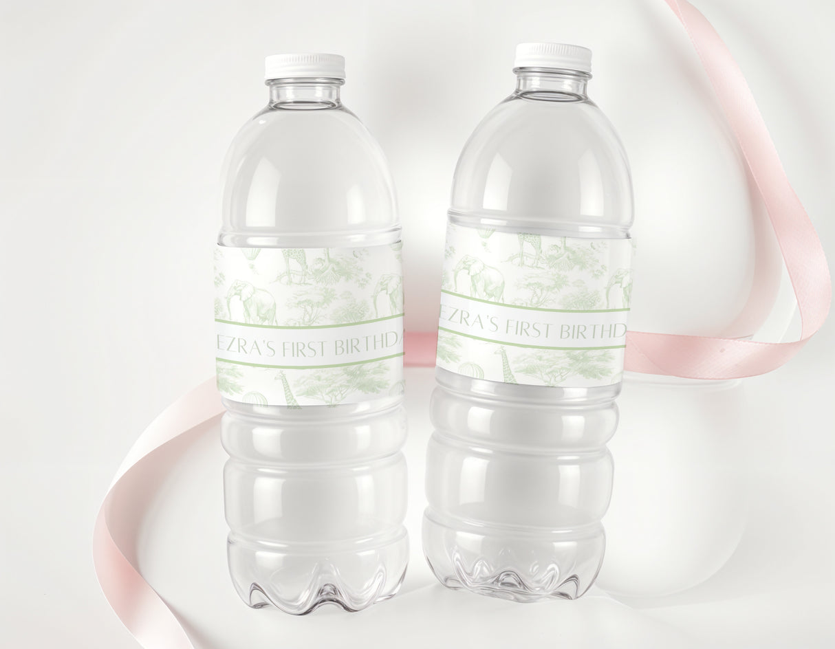 Two clear plastic water bottles with green safari-style personalised first birthday labels