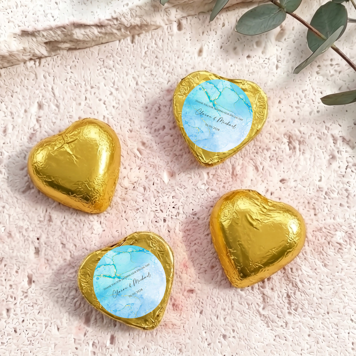 Foil-covered chocolate hearts in gold with personalized blue label on top