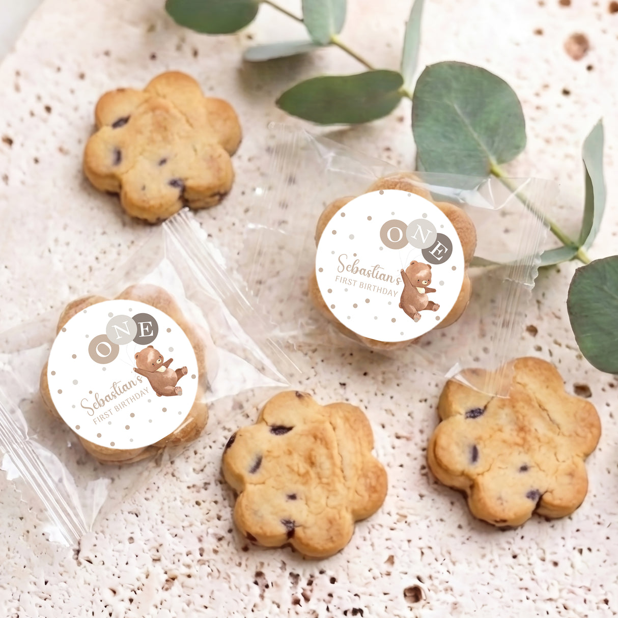 Personalised chocolate chip cookies with two round bear labels and several biscuits