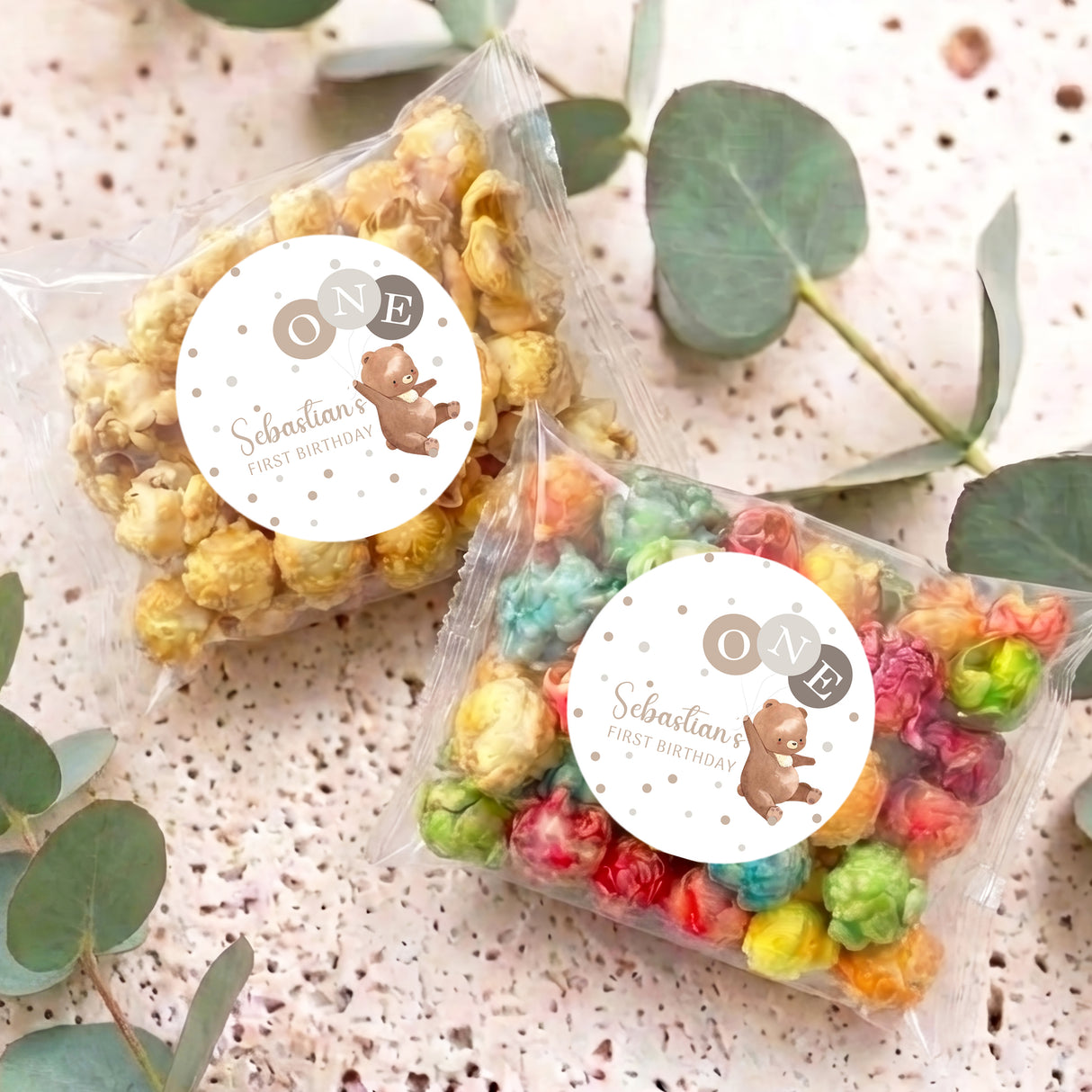 Personalised popcorn bags with clear wrap and rainbow popcorn, round 'ONE' bear labels