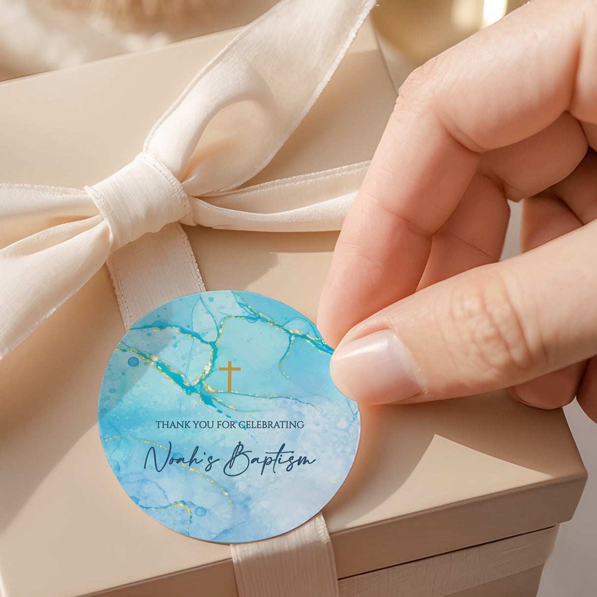 Blue round baptism label with gold cross and text “Thank you for celebrating”