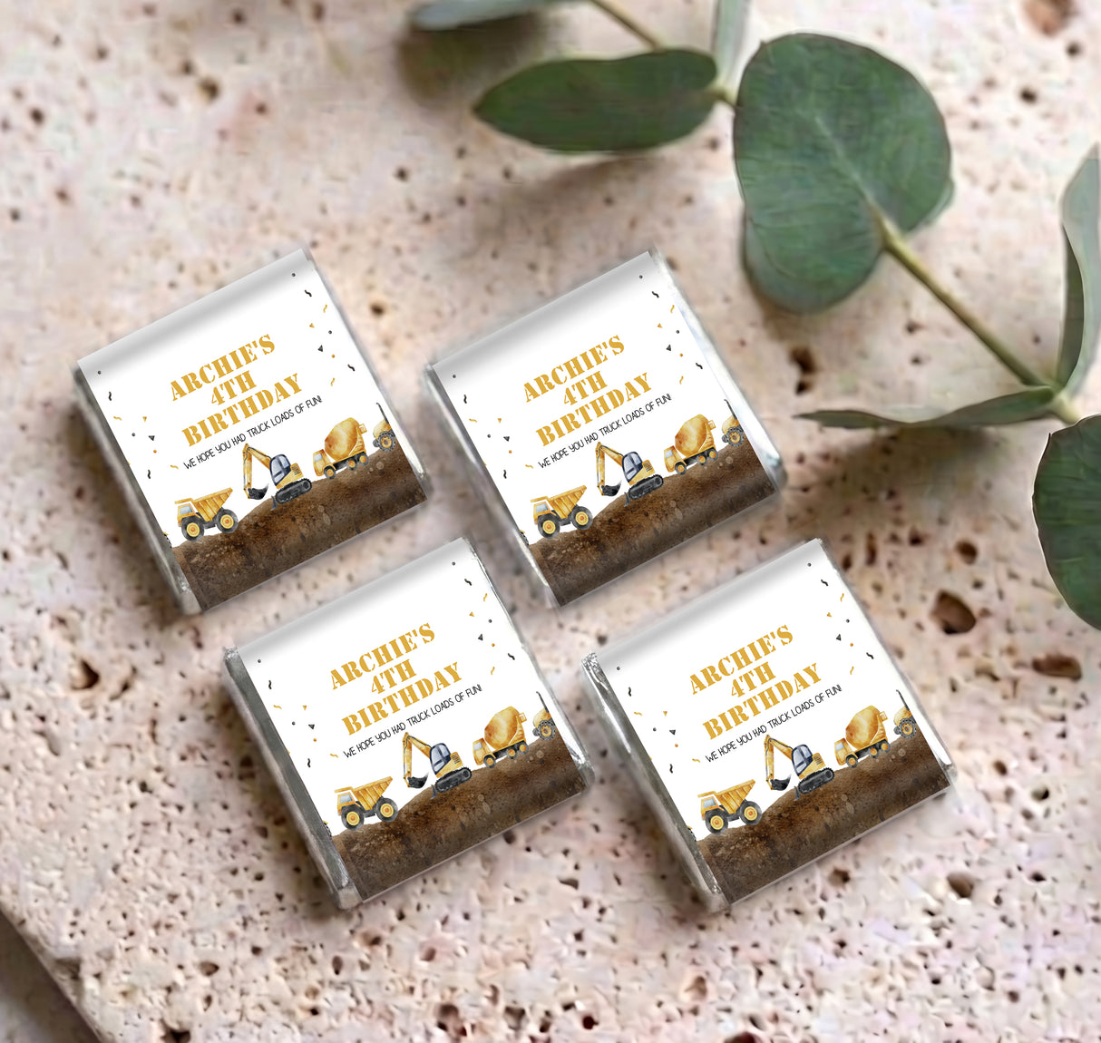 Four personalised mini chocolates with construction trucks and “Archie’s 4th Birthday”
