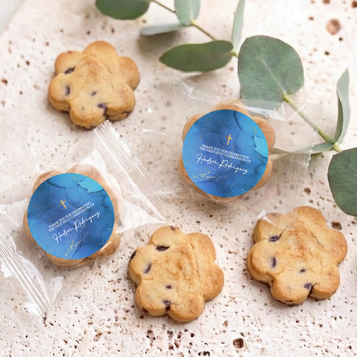 Chocolate chip cookies in clear bags with blue First Communion gold cross round labels