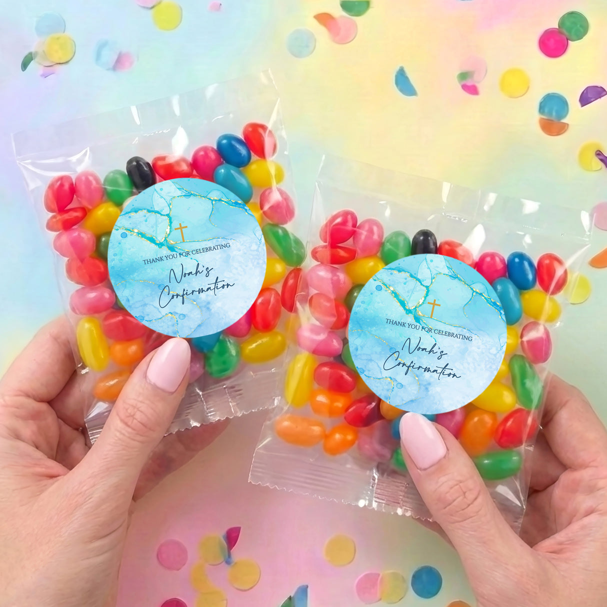 Two personalized jelly bean bags with light blue round labels and mixed-color candies