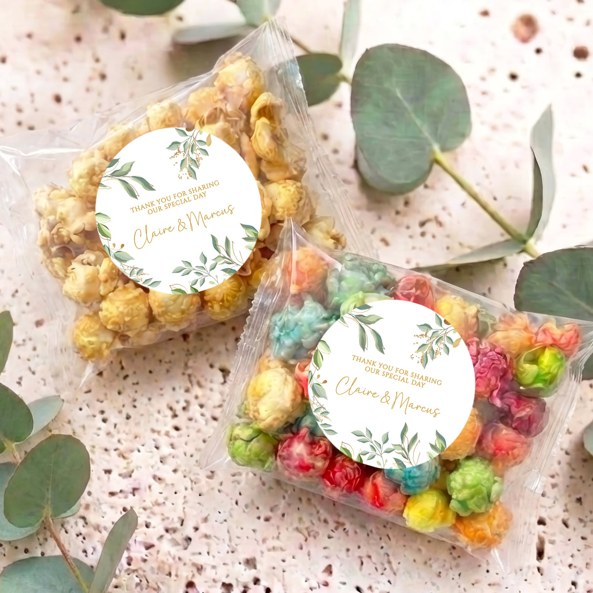 Two clear popcorn bags with round eucalyptus wreath personalised wedding labels