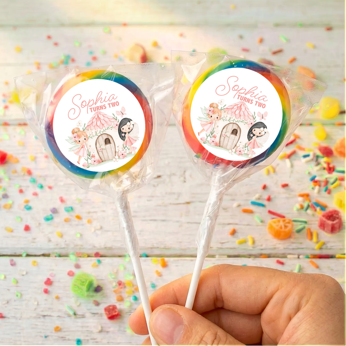 Personalised lollipops on sticks with round Sophia turns two labels, blue-green border