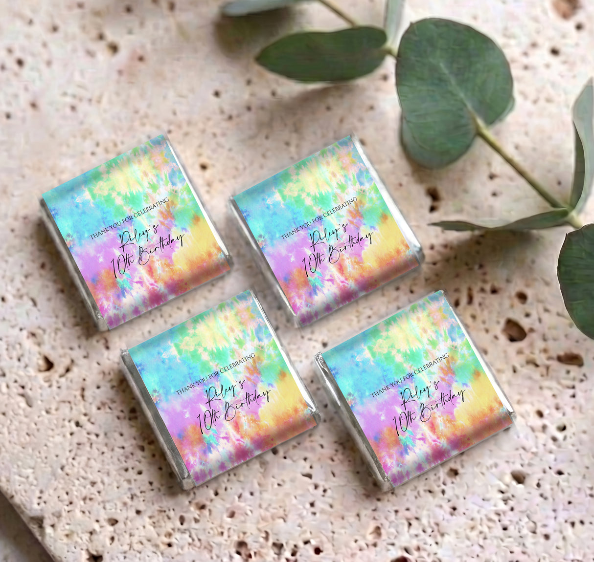 Set of four tie dye mini chocolate boxes with pastel rainbow design on foil