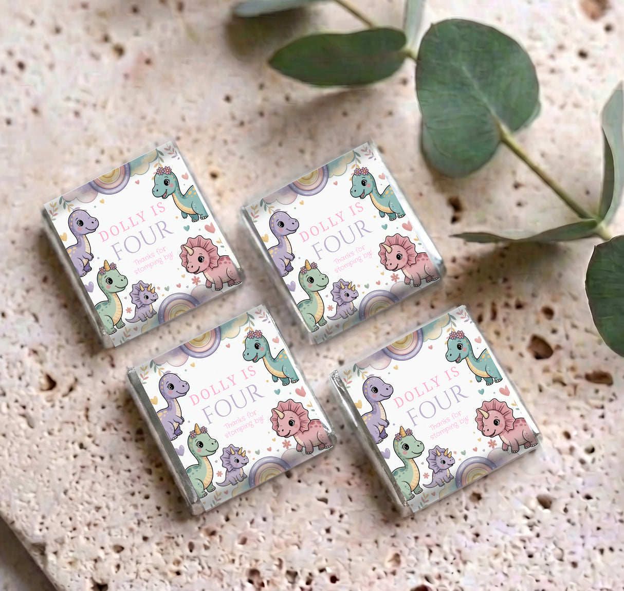 Four pastel dinosaur mini chocolate boxes, each showing “Dolly is Four”