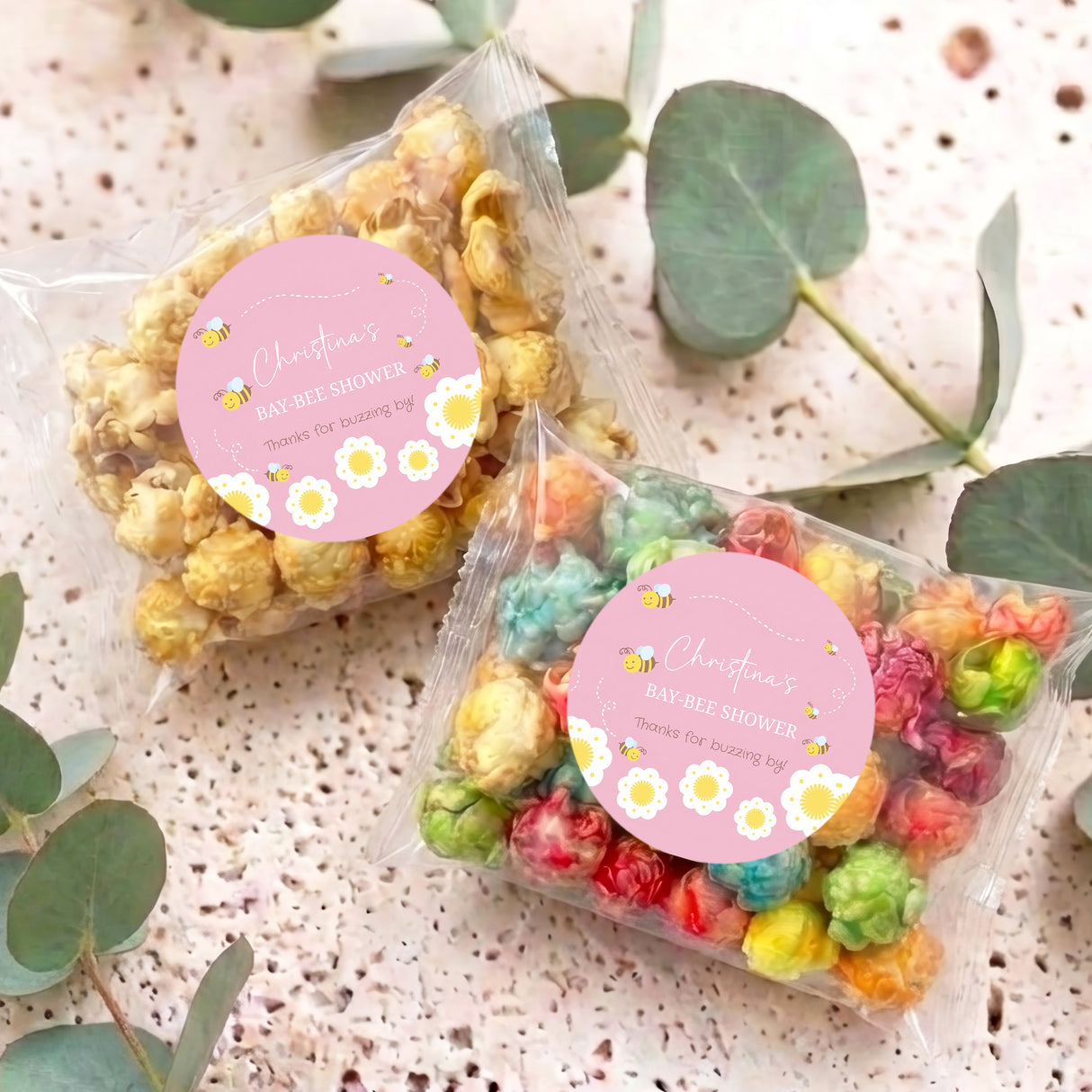 Set of two colorful popcorn bags with round pink bee Bay-Bee Shower labels