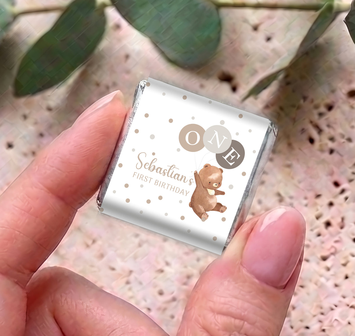 Personalised mini chocolates with white wrapper, bear graphic, 'ONE' emblem, and 'Sebastian' text