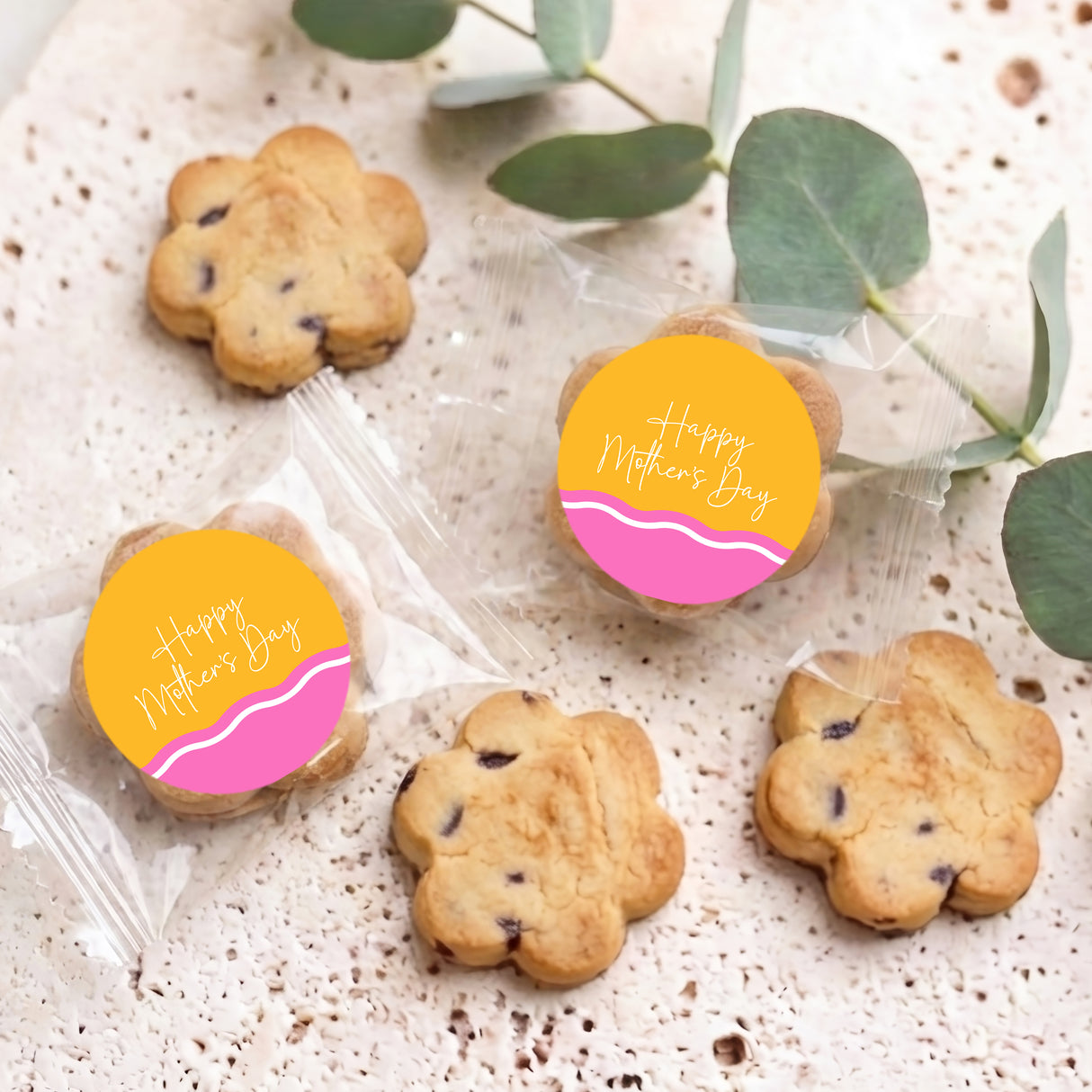 Mini chocolate chip cookies with “Happy Mother’s Day” labels, two in clear cellophane bags