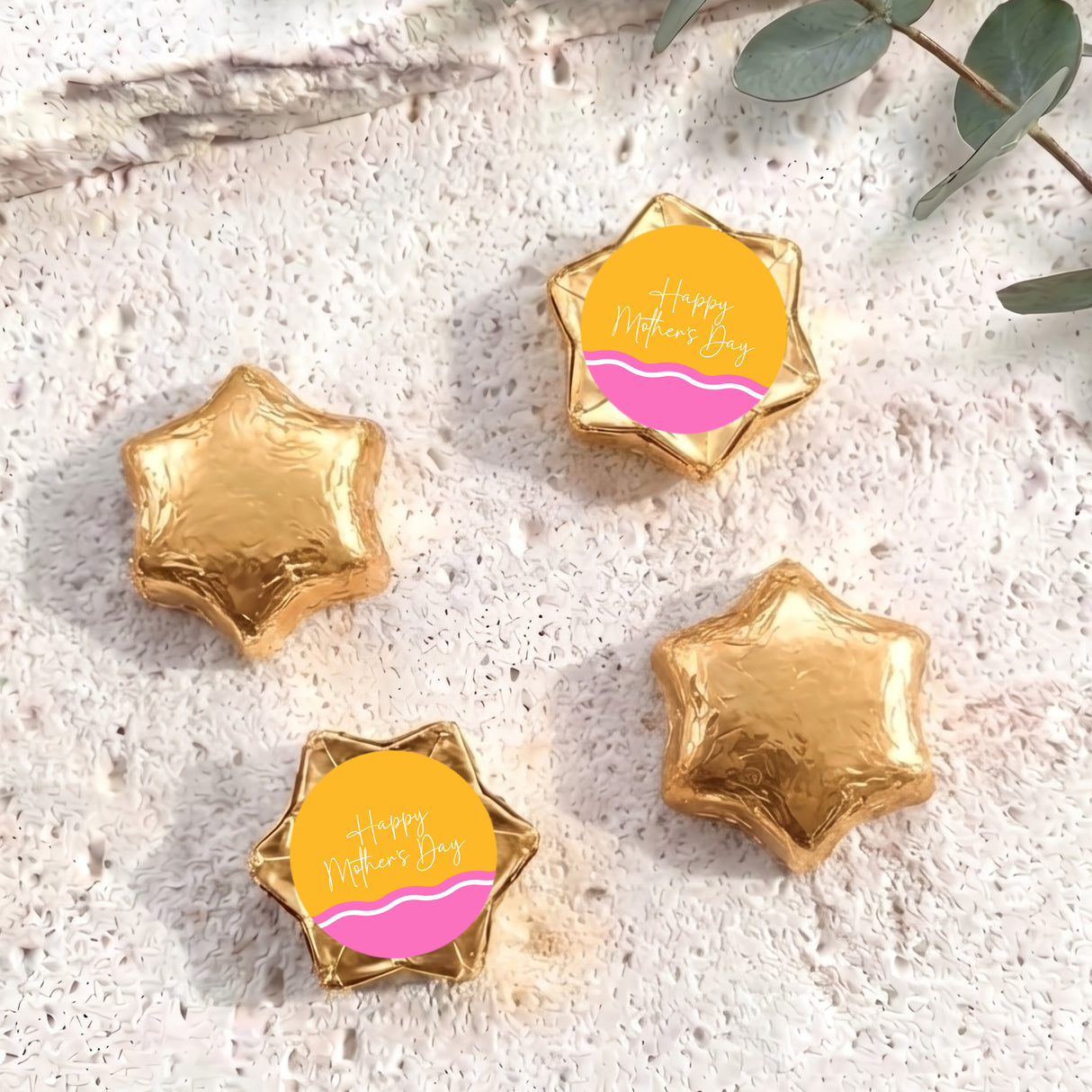 Gold foil star chocolates with “Happy Mother’s Day” label, arranged in set.