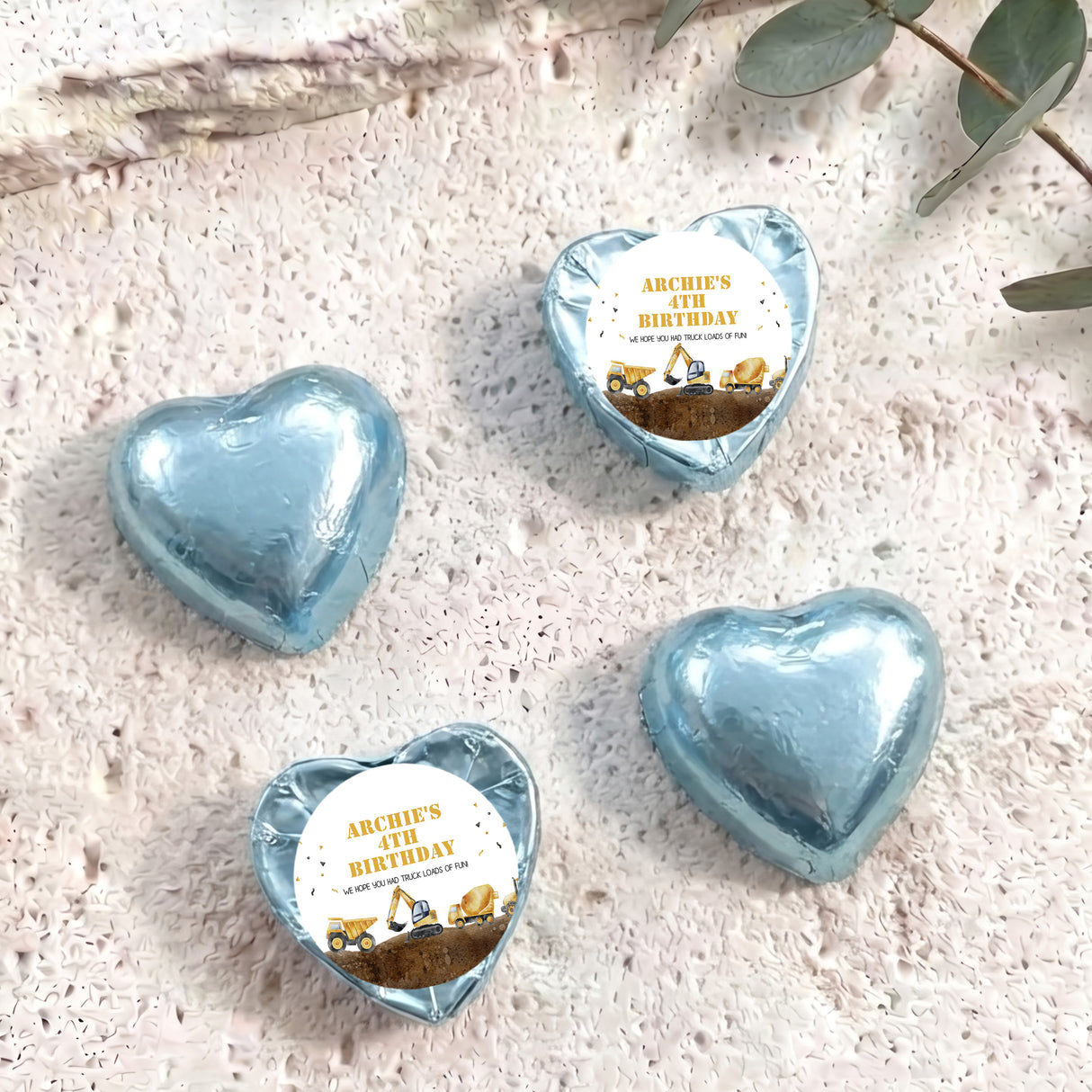 Foil-covered chocolate hearts in light blue with birthday label featuring a construction truck