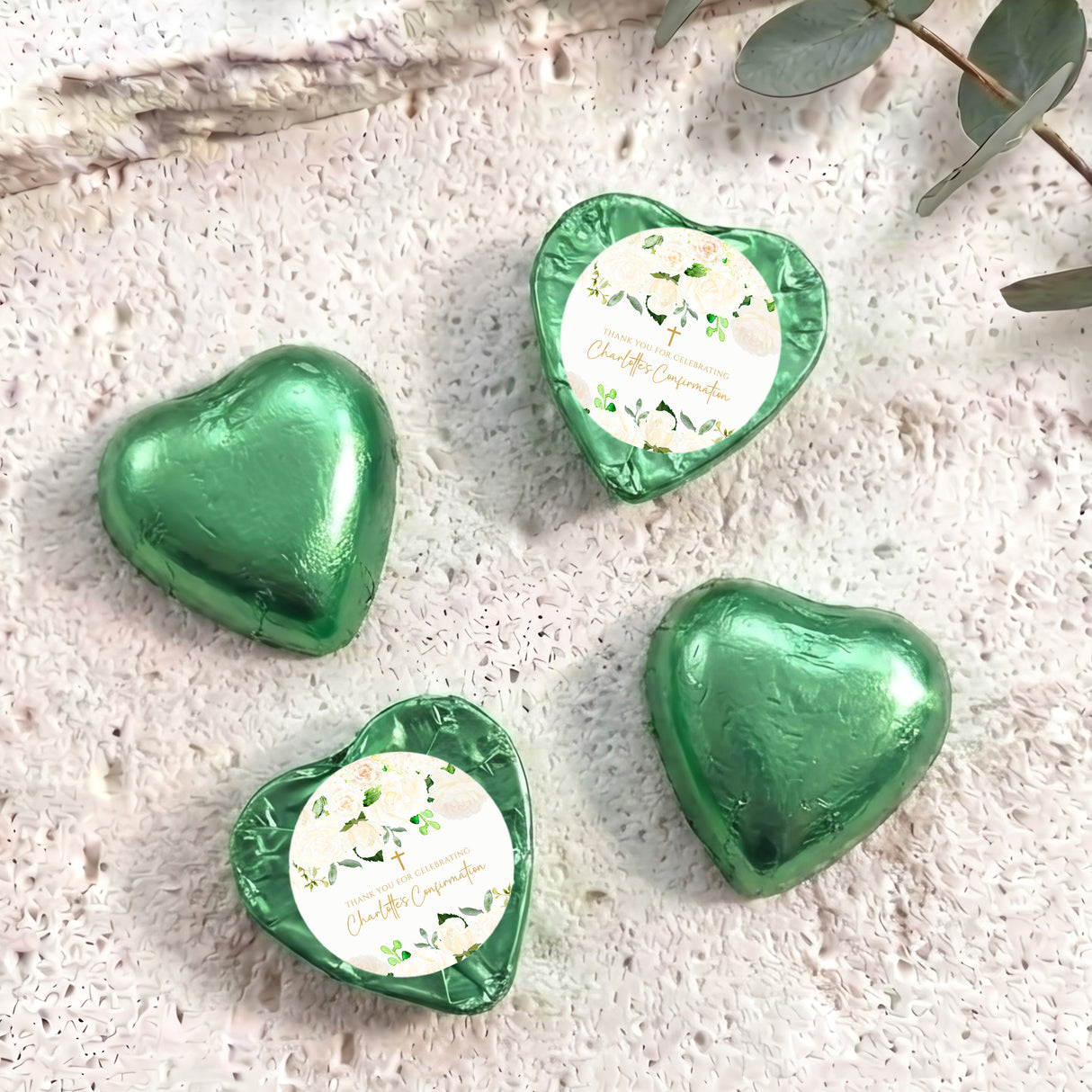 Foil-covered chocolate hearts in green, with floral white labels
