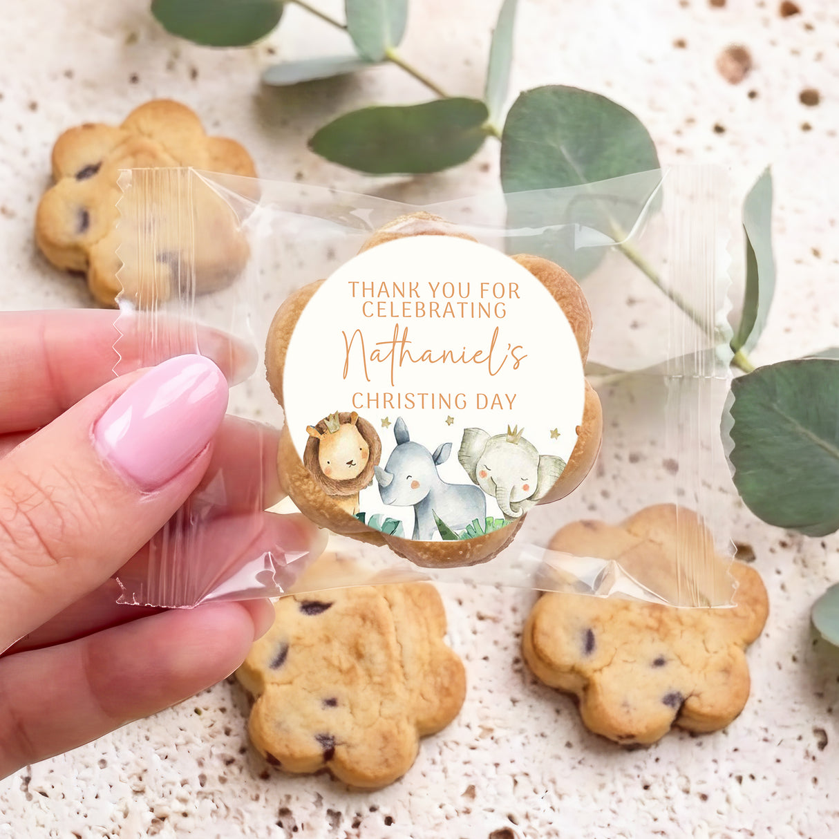 Chocolate chip cookies with round christening label and watercolor baby animals detail