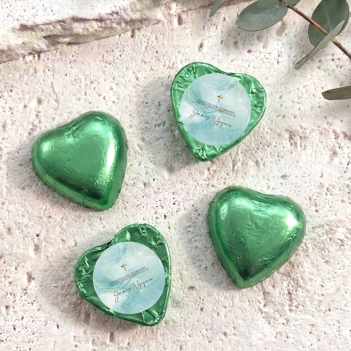 Green foil heart chocolates, one with blue center and gold cross