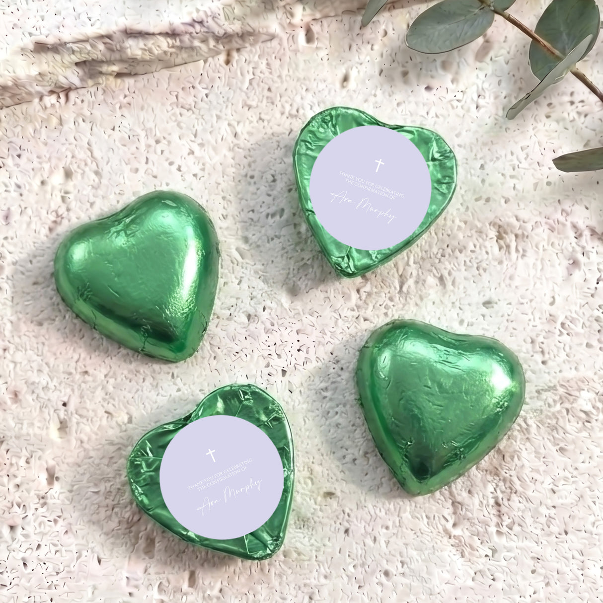 Foil-covered chocolate hearts, green foil with white tops and small cross