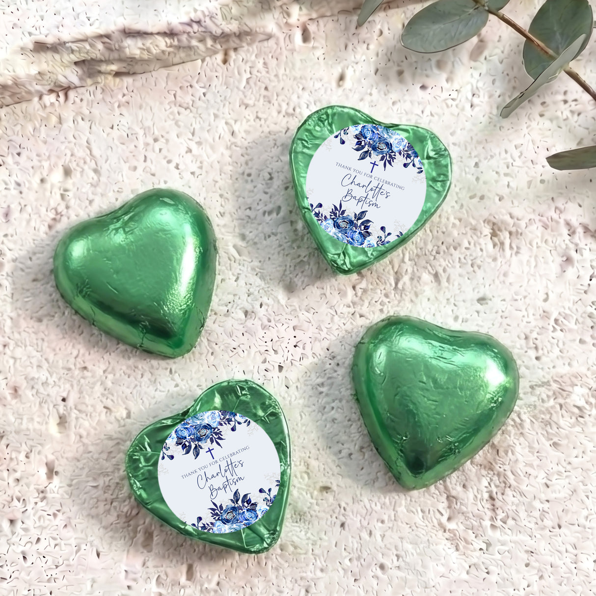 Green foil-covered chocolate hearts with floral christening label