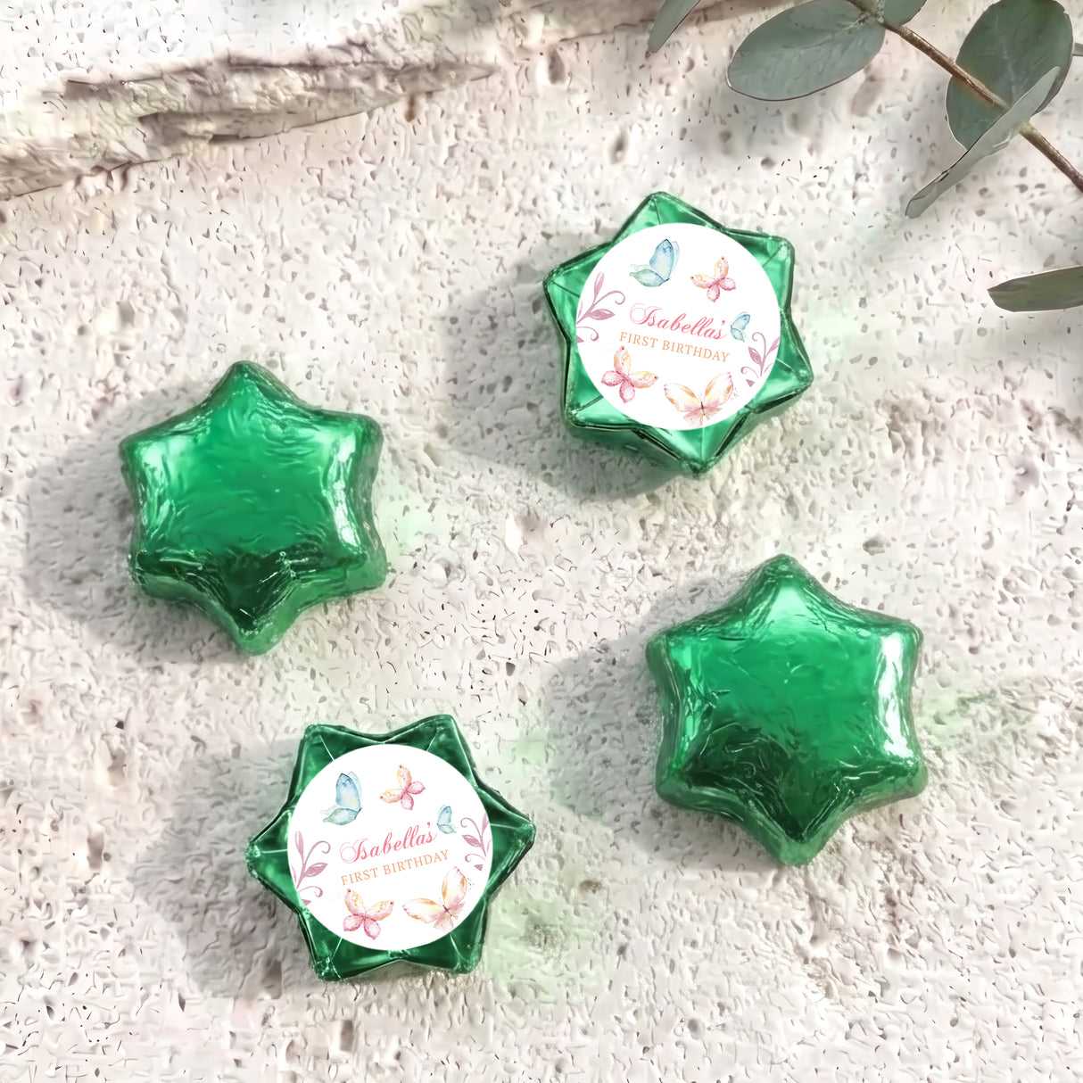 Green foil-covered chocolate stars with a round personalised label on one star