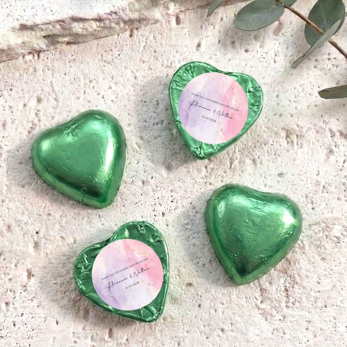 Foil-covered chocolate heart in green with round white name label and foil rim