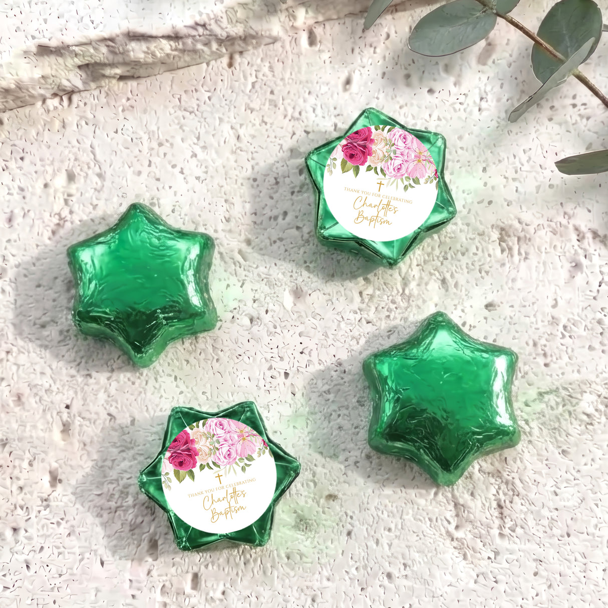 Foil-covered chocolate stars with floral personalized label, green foil shapes