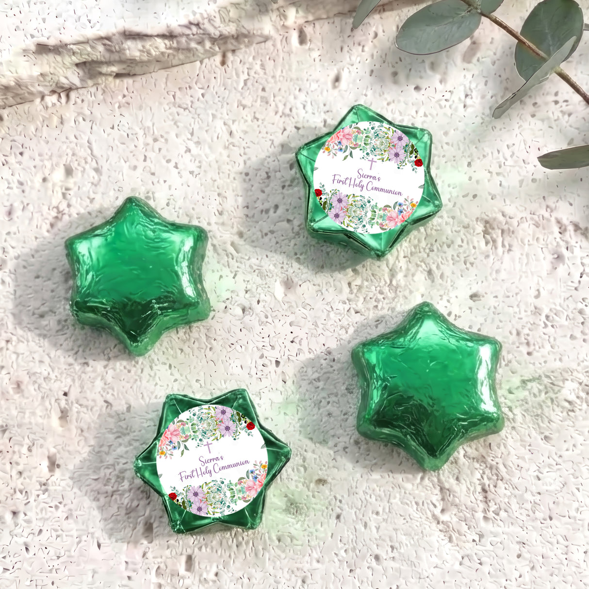 Green star-shaped foil-covered chocolate favors with floral First Communion label