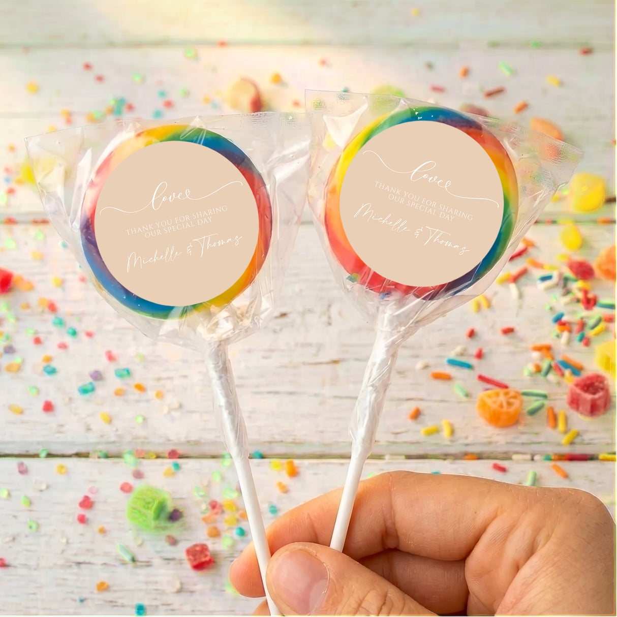 Personalised wedding lollipops with multicolor swirl tops and beige thank-you labels