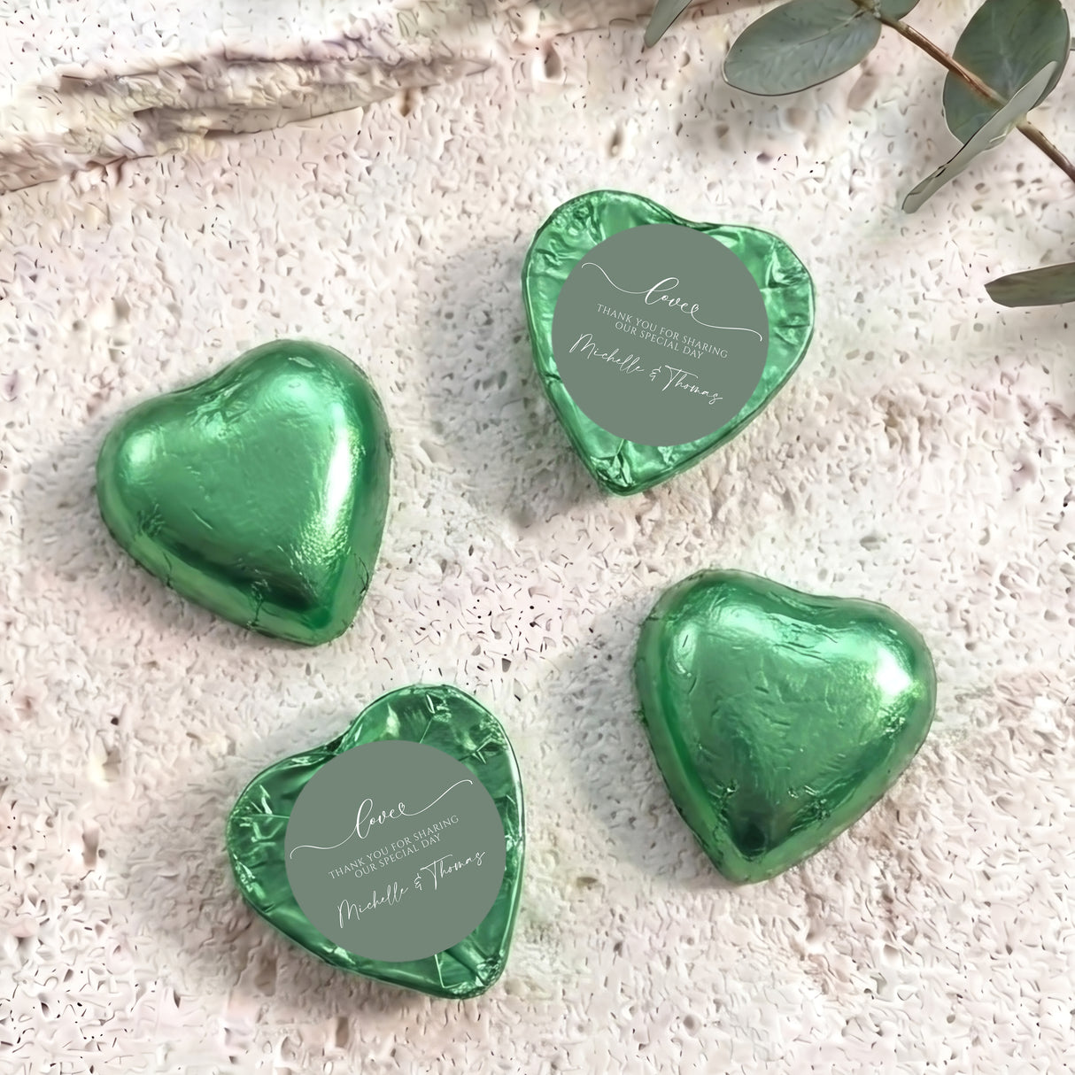 Sage green foil-covered heart chocolates with round personalized thank-you labels